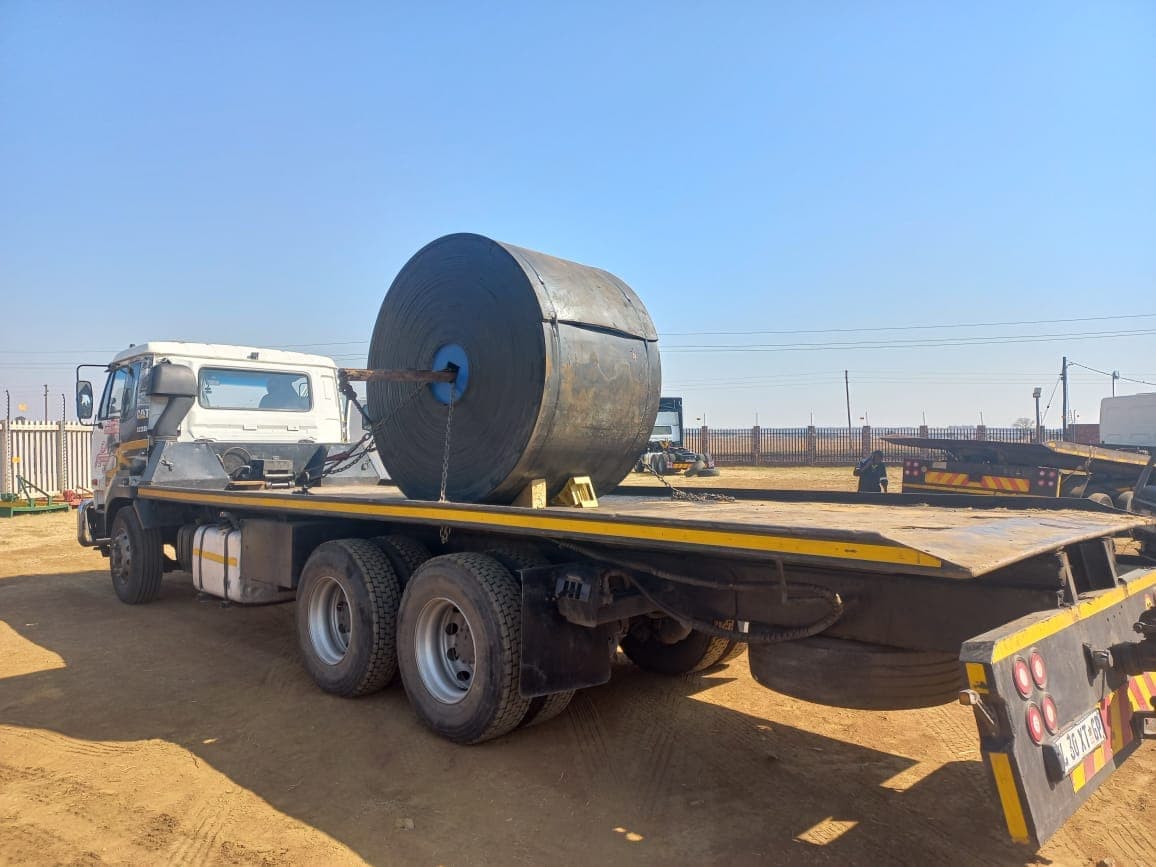 A large roll of conveyor belting chained down on a flatbed truck, ready for a Kia-Kaha Mining site delivery