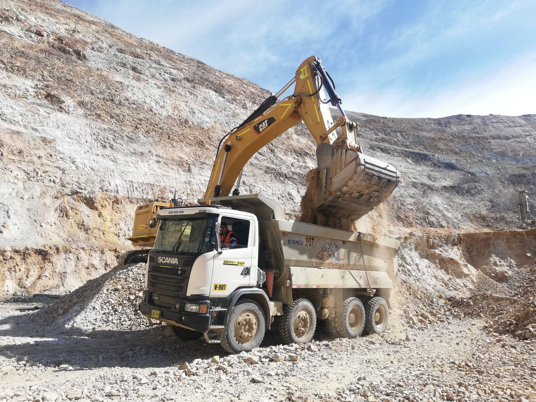 Heavy earthmoving equipment operating in an open-pit mine