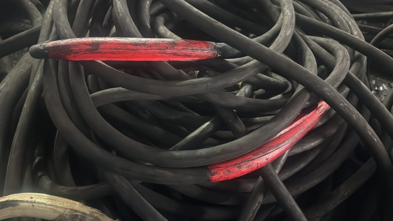 Two Bosworth Flexable resin joints in red on heavy trailing cables among a coiled cable stack