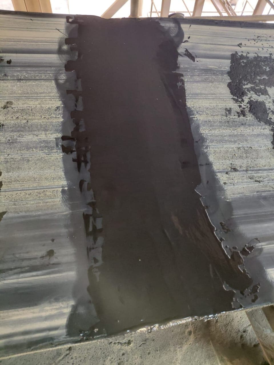 A fresh KK-Fix repair over a belt splice, compound built up flush with the belt surface